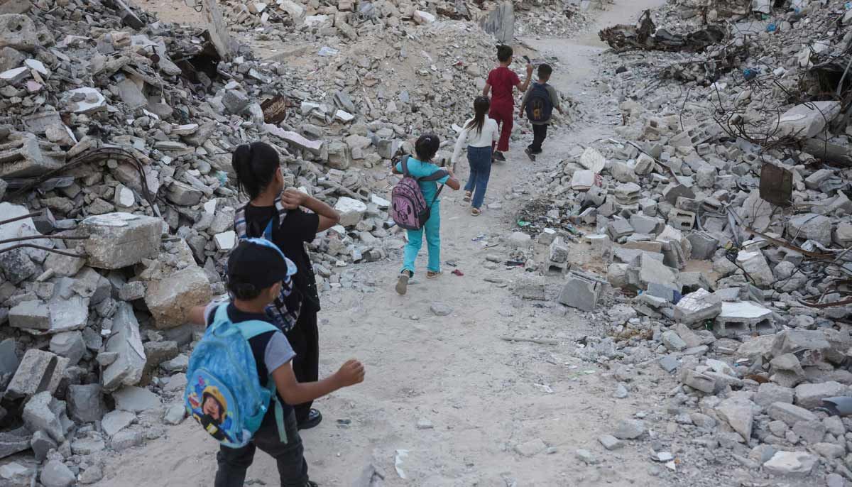 Palestinian children walk to school amid the rubble of destroyed buildings as the academic year begins in Khan Yunis, in the southern Gaza Strip on September 19, 2026.— AFP