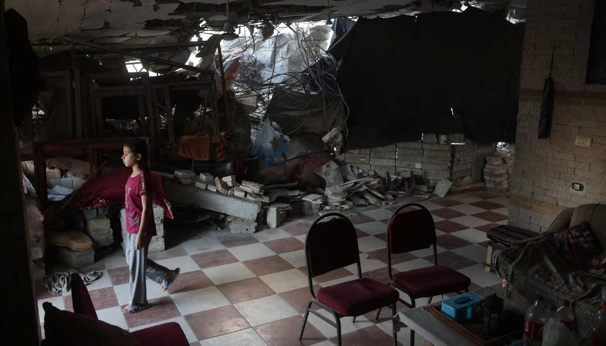 A displaced Palestinian girl stands inside a heavily damaged building in Khan Yunis in the southern Gaza Strip on September 19, 2026. — AFP