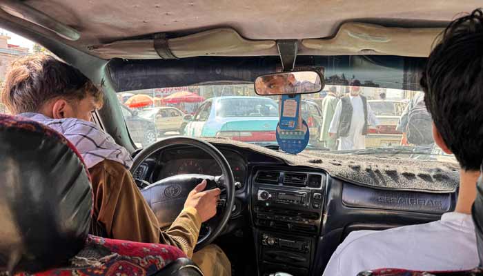 The picture shows a music playback screen on the stereo as an Afghan taxi driver transports passengers in Kabul. — AFP