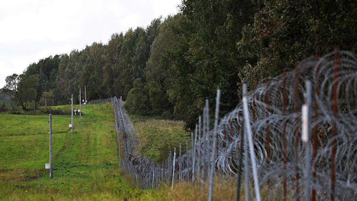A razor-wire boundary fence is seen along the Polish-Lithuanian border with the Russian exclave of Kaliningrad near the village of Grzybina