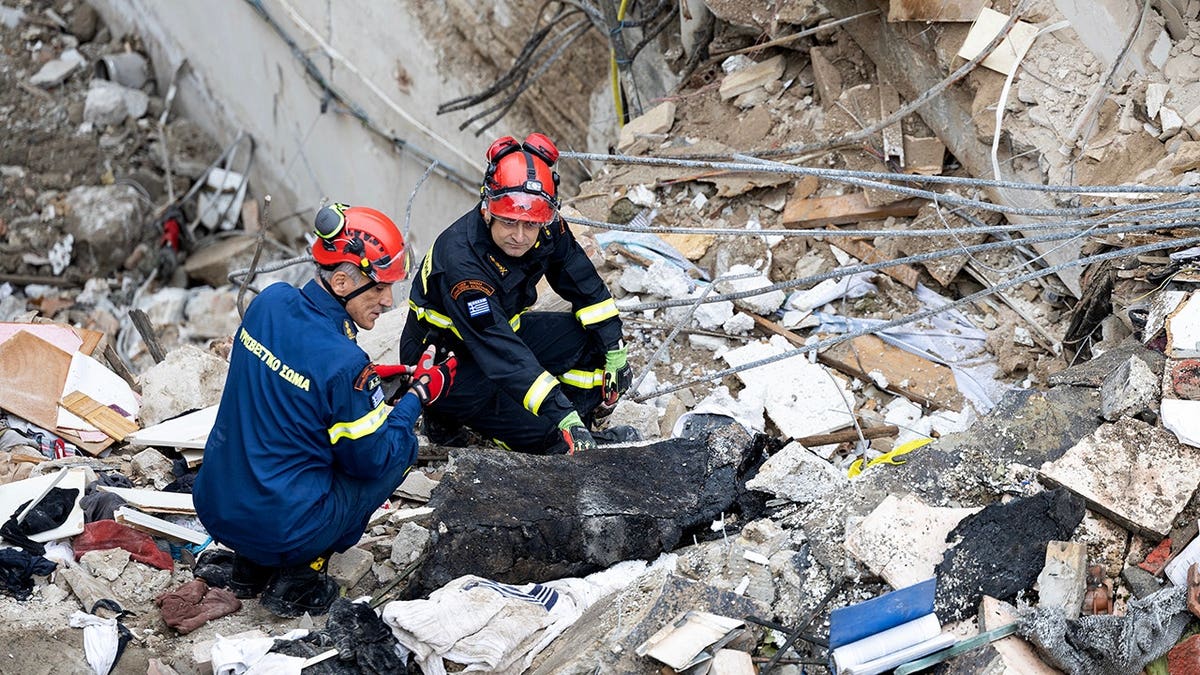 Firefighters work at the scene following a blast in Athens' Plaka district.