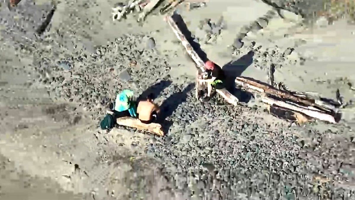 three are shown from a drone stranded on Lost Boy Beach