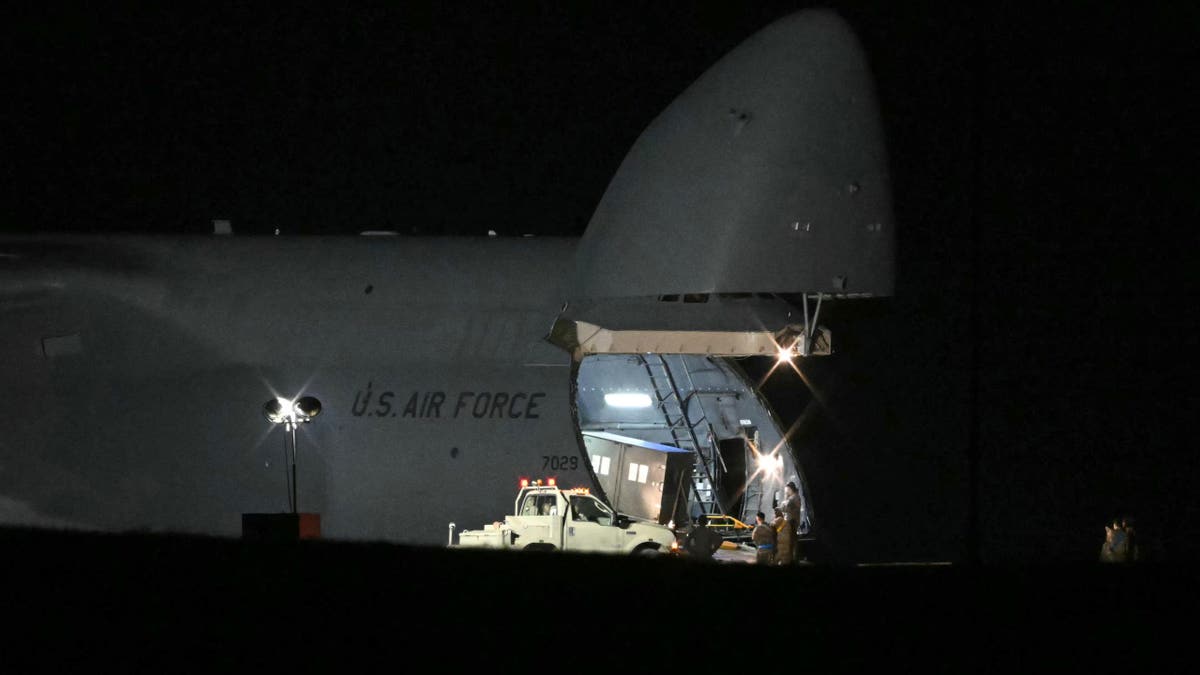 Members of the US military offload equipment from a US Air Force C-5 Galaxy at RAF Fairford in south west England on March 6, 2026. Britain's Prime Minister Keir Starmer has given approval for Washington to use the bases of Diego Garcia in the Indian Ocean and RAF Fairford in southwest England to bomb Iranian missile sites, after several Gulf countries were targeted by Iranian retaliations. (Photo by JUSTIN TALLIS / AFP via Getty Images)