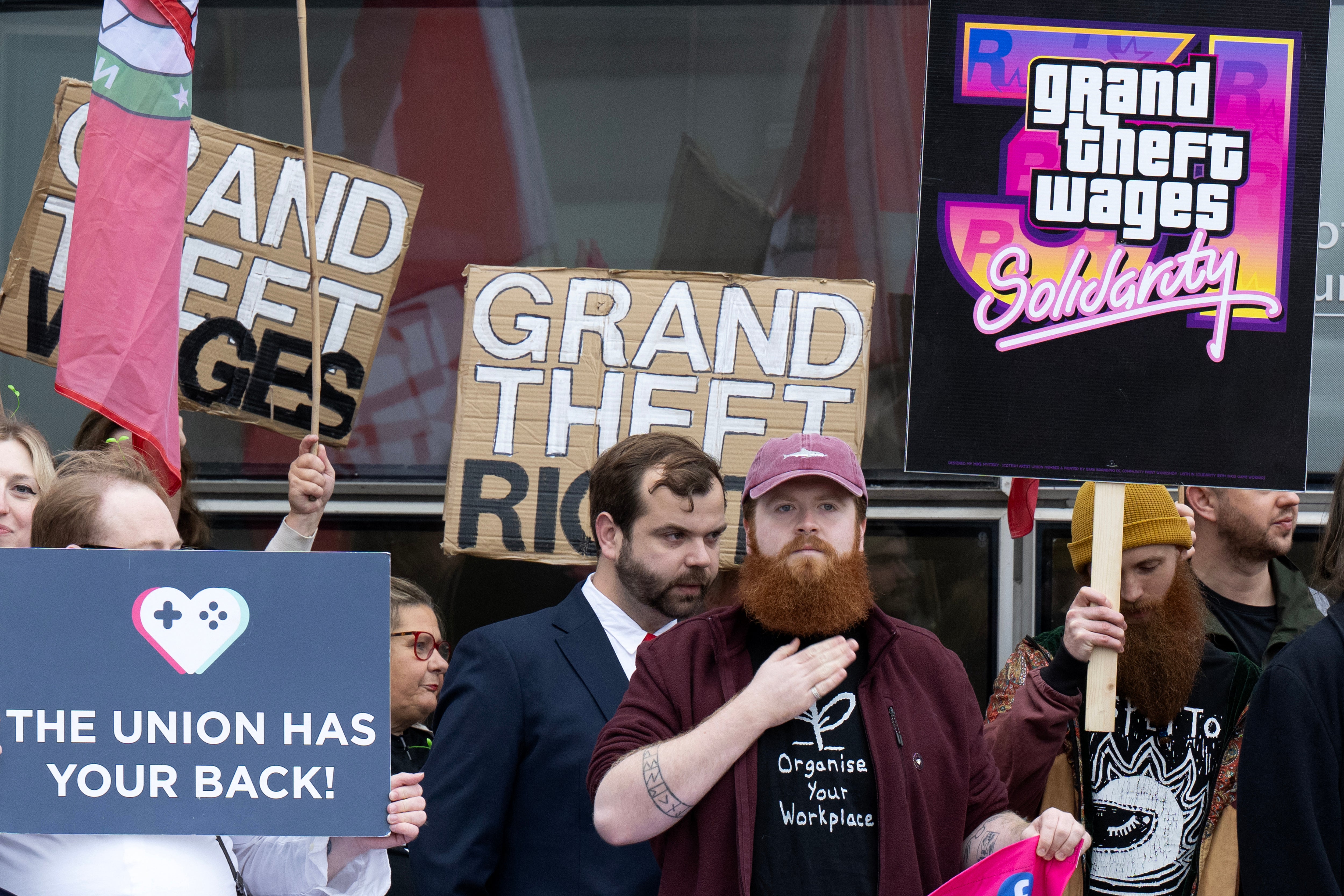 Protesters hold placards as they take part in a rally outside the Glasgow Tribunal Centre as representatives from Rockstar Games, the publisher of GTA VI (Grand Theft Auto), are expected at an employment tribunal in Glasgow