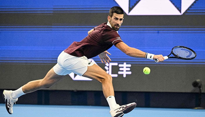 Serbias Novak Djokovic hits a return to Australias Alex de Minaur during the mens singles final at the China Open tennis tournament in Beijing on October 6, 2026. — AFP