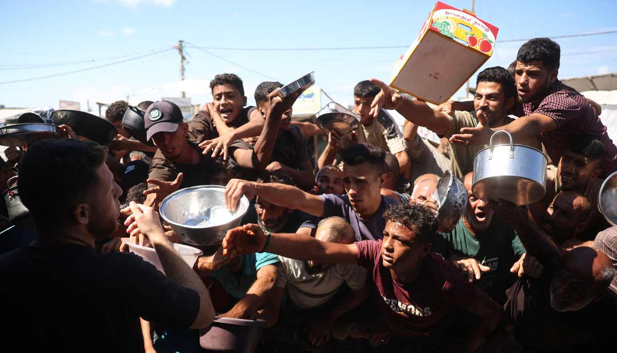 Displaced Palestinians waiting to receive food at a charity kitchen in Khan Yunis, in the southern Gaza Strip.— AFP
