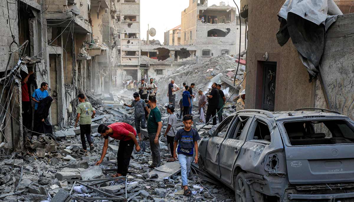 People search the rubble of a collapsed building following overnight Israeli airstrikes in Gaza City on October 9, 2026. — AFP