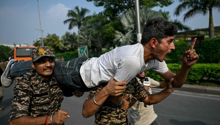 Security personnel detain a student activist during a protest demanding the resignation of the nations Chief Election Commissioner Gyanesh Kumar over alleged voter roll irregularities linked to the special intensive revision (SIR), in New Delhi, India, October 13, 2026. — AFP