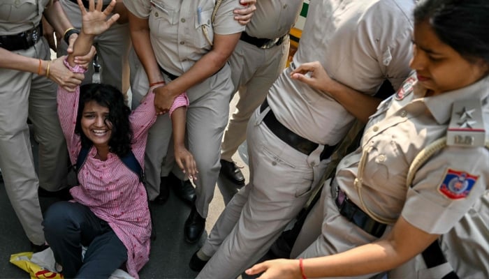 Delhi Police personnel detain a student activist during a protest demanding the resignation of the nations Chief Election Commissioner Gyanesh Kumar over alleged voter roll irregularities linked to the special intensive revision (SIR), in New Delhi, India October 13, 2026. — AFP