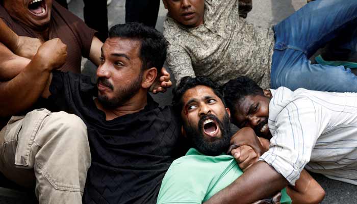 Protesters react as they are detained by security personnel during a protest by the Cockroach Janta Party (CJP) seeking the resignation of Indias Chief Election Commissioner Gyanesh Kumar, near the protest site in New Delhi, India, October 11, 2026. — Reuters