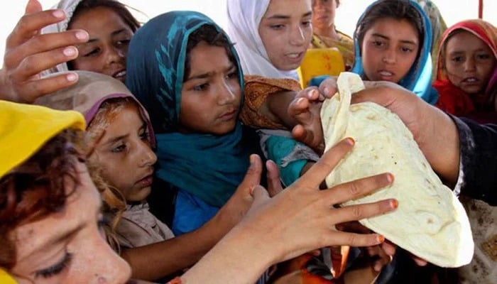 This photo shows girls taking bread. — AFP/File