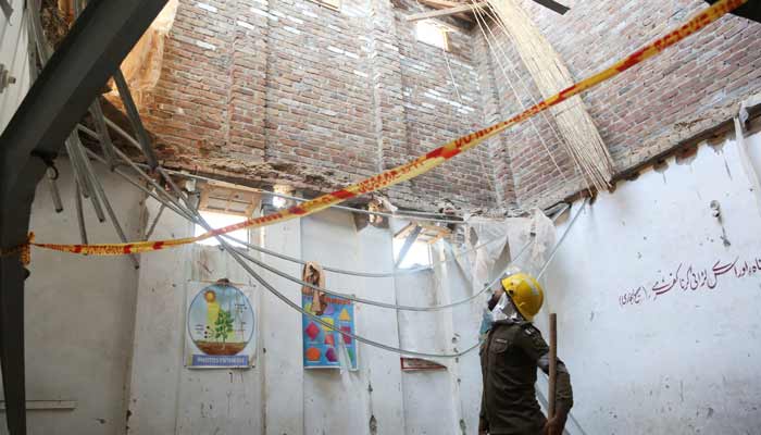 A rescue staff stands in a classroom after a school roof collapse in Peshawar, Pakistan, October 15, 2026.— Reuters