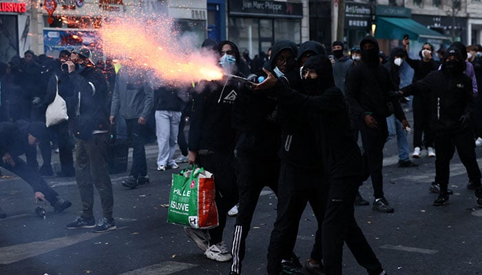 A protester uses a fireworks amid clashes during a day of demonstrations against the cost of living and rising fuel prices in Paris, France, October 17, 2026. — Reuters