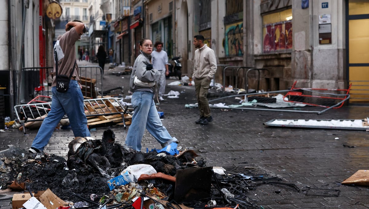 People walk past piles of trash, the day after clashes during a national day of demonstrations against the cost of living and rising fuel prices, in Marseille, France, October 18, 2026. — Reuters