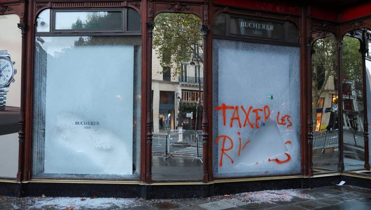 Shards of glass lie on the ground next to damaged Bucherer store, the day after clashes during a national day of demonstrations against the cost of living and rising fuel prices, in Paris, France, October 18, 2026. — Reuters