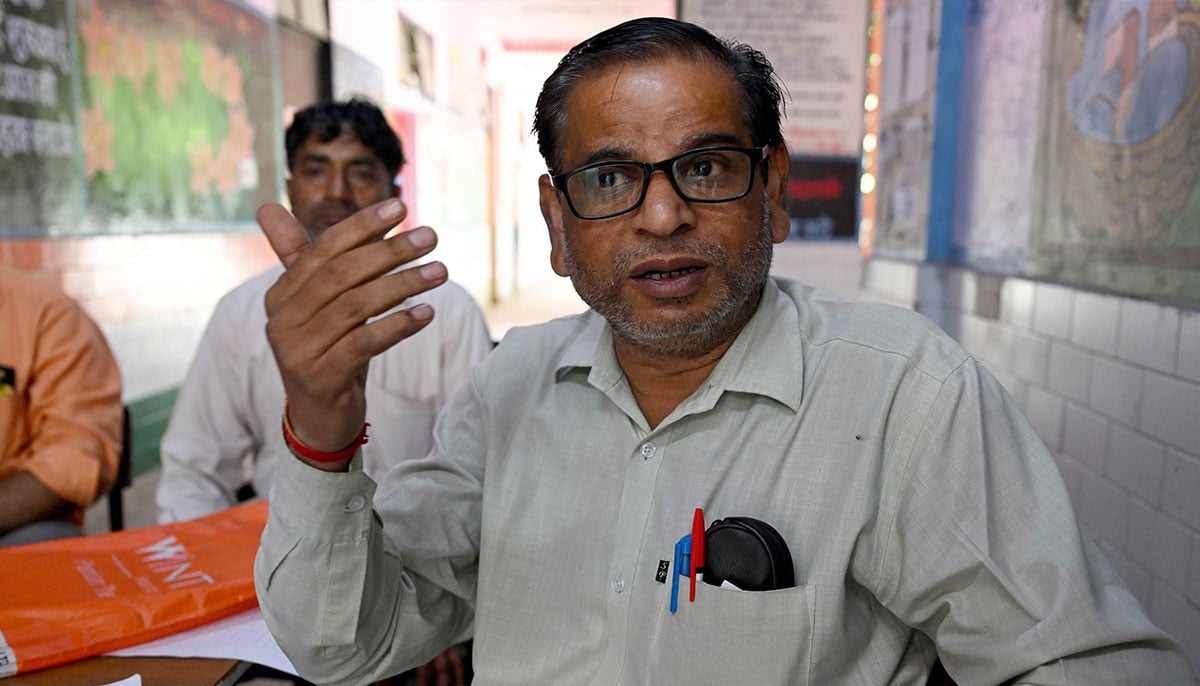 Booth level-officer (BLO) Mukesh Khanna speaks during a interview with AFP as he assists people to register their documents for the Draft Electoral Roll 2026 as part of the Election Commission of Indias Special Intensive Revision (SIR), at a voter verification camp in New Delhi on October 18, 2026. — AFP