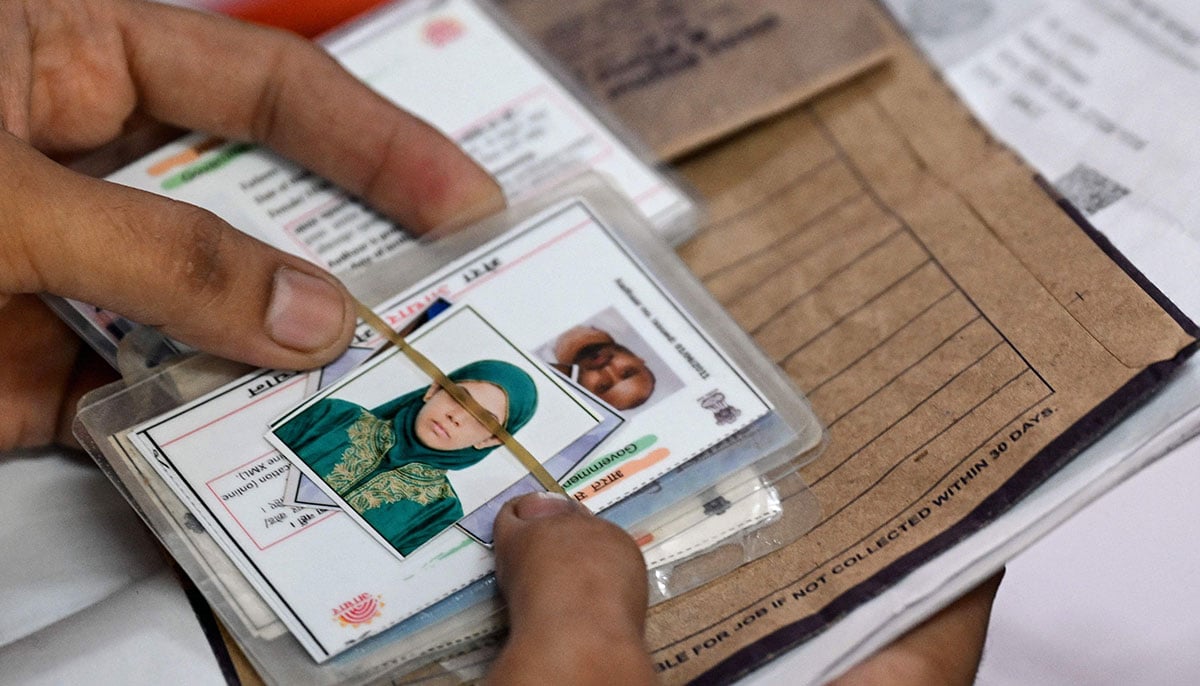 A man waits with documents to register for the Draft Electoral Roll 2026 as part of the Election Commission of Indias Special Intensive Revision (SIR), at a voter verification camp in New Delhi on October 18, 2026. — AFP