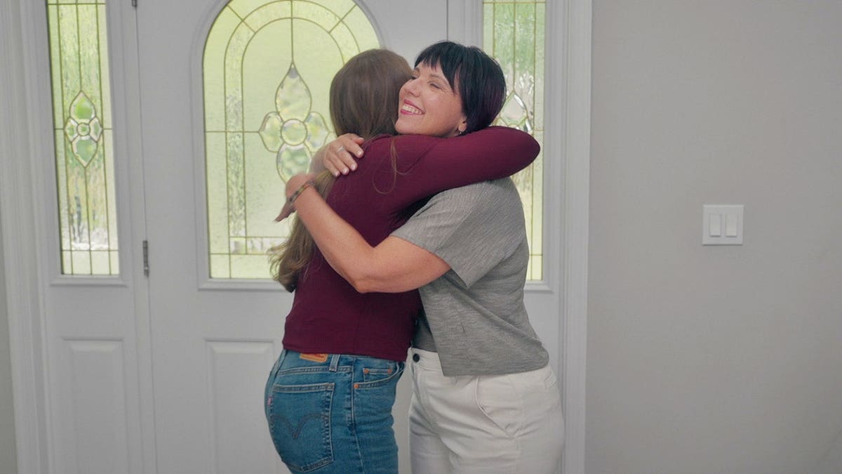 Bonnie Lou Gower hugging Kara Robinson Chamberlain.