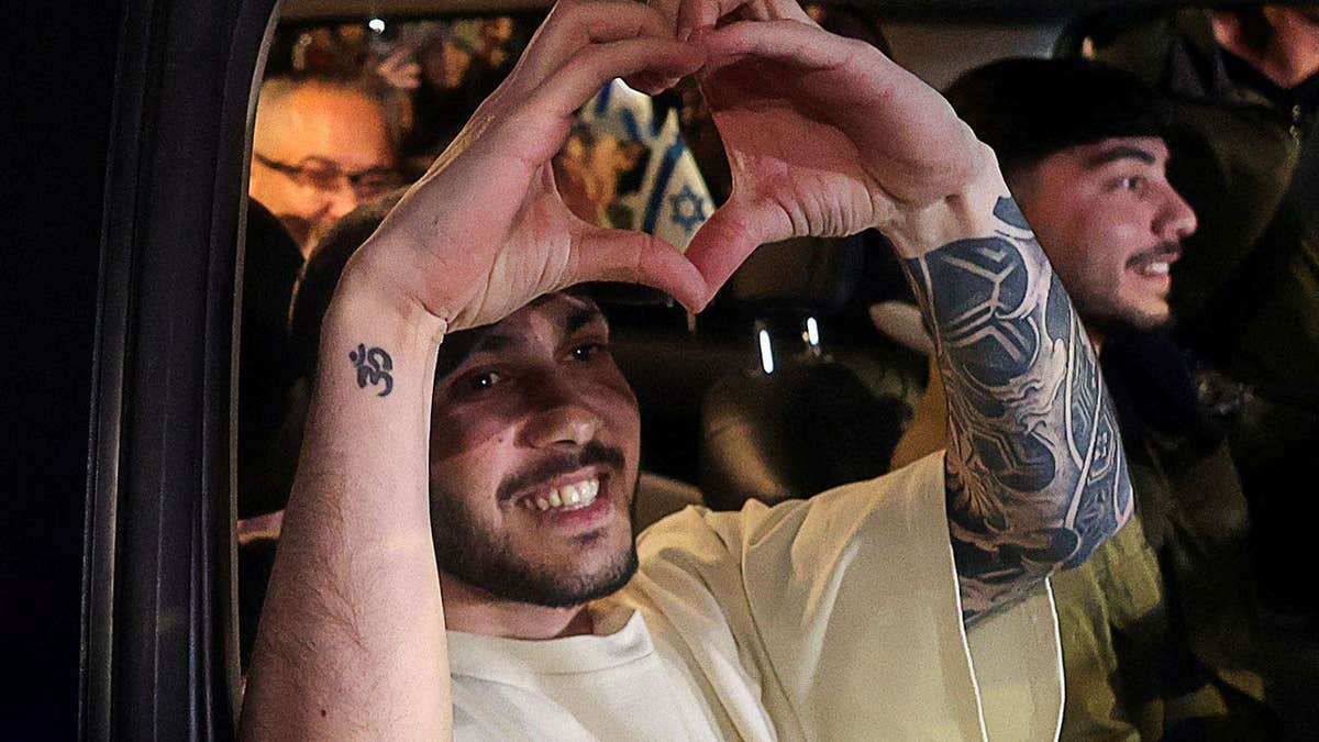 Eliya Cohen who was kidnapped during the deadly October 7, 2023, attack on Israel by Hamas, held in Gaza and released recently, gestures, as a crowd welcomes him