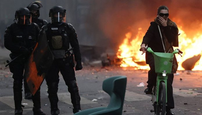 French police clash with protesters as tens of thousands rally over cost of living