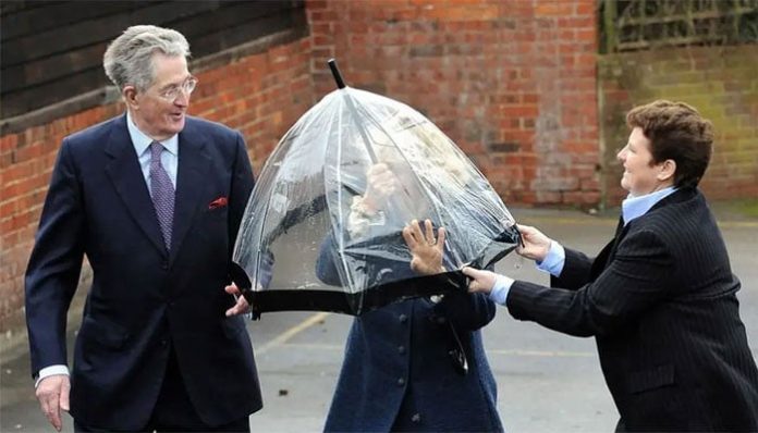 Queen Camilla gets caught in royal pickle after umbrella turns against her