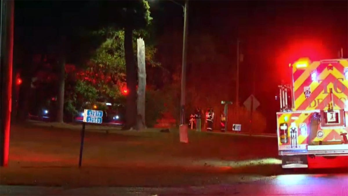 First responders stand at a small plane crash scene in Dellona, Wisconsin.