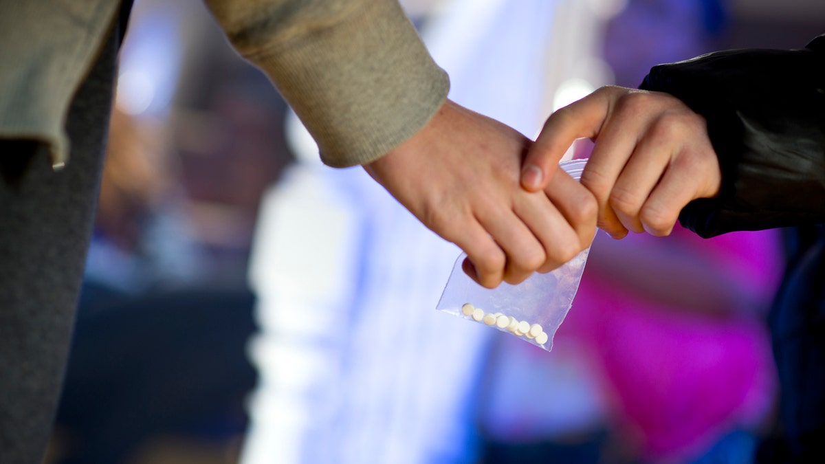 ecstasy being handed over at a house party..