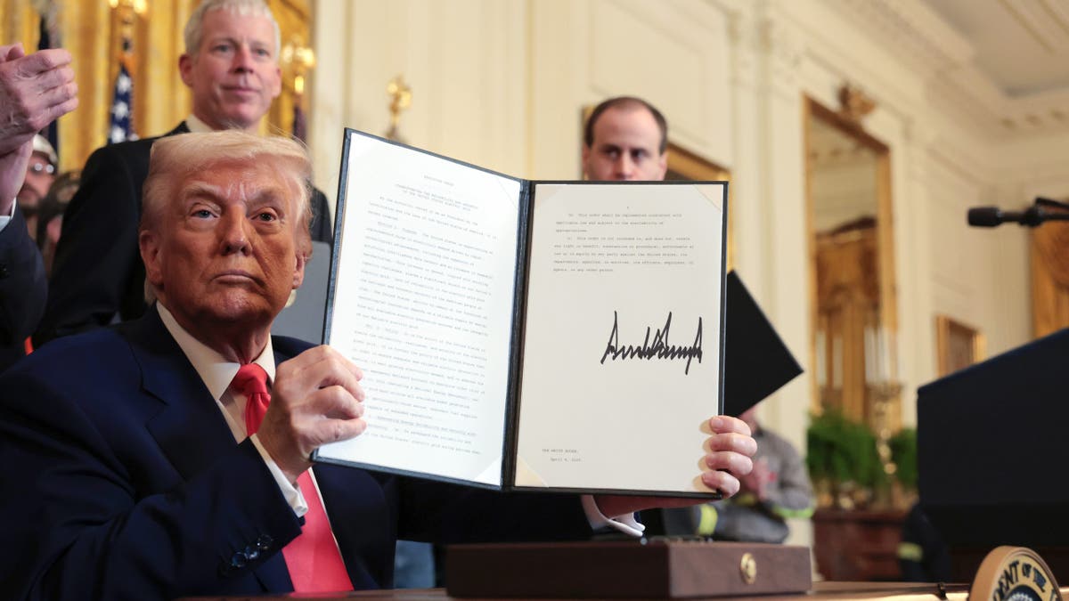 WASHINGTON, DC - APRIL 08: U.S. President Donald Trump holds up an executive order on American energy production after signing it during a ceremony in the East Room of the White House on April 08, 2025 in Washington, DC. The Trump administration has elected to roll back Biden-era environmental policies with the intention to help revive coal-fired plants in order to restore America’s energy independence.