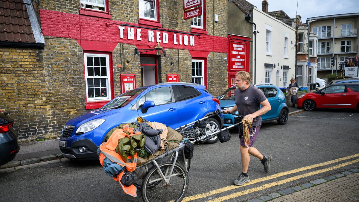 Karl Bushby pushes a cart through Dover, England.