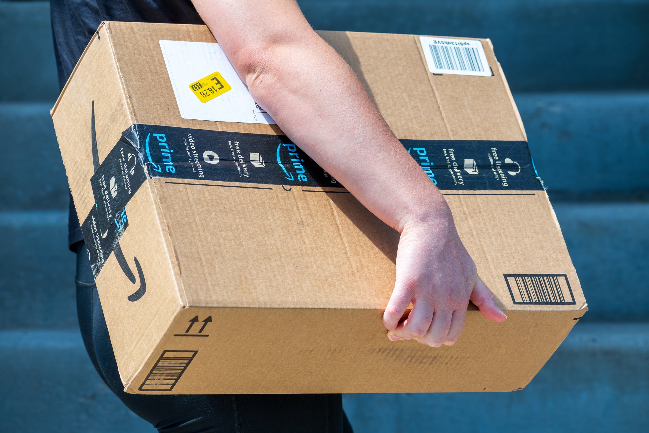 An Amazon Flex driver delivers a large cardboard box