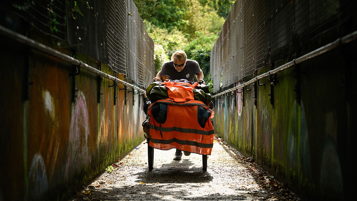 DOVER, ENGLAND - OCTOBER 09: Global adventurer Karl Bushby tackles a steep incline as he begins the route towards the North, on October 09, 2026 in Dover, England. Karl Bushby first set off from Chile in November 1998 with the mission of traversing the world on foot without the use of transport, and only returning home to the UK once the journey was complete. After trekking nearly 28 years and 30,000 miles (48,000km) through 29 countries, the former British paratrooper completed a multi-day swim across the English Channel on October 5, touching back on UK soil for the first time in Dover. The final leg of the remarkable journey he refers to as the Goliath Expedition will see Bushby walk more than 250 miles (400km) to his mother's home in Hull, northeast England. (Photo by Leon Neal/Getty Images)