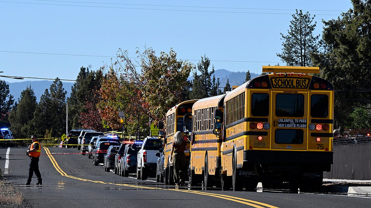 School buses are lined up outside Silver Rail Elementary school, where a shooting took place, on Thursday, Oct. 15, 2026 in Bend, Ore.