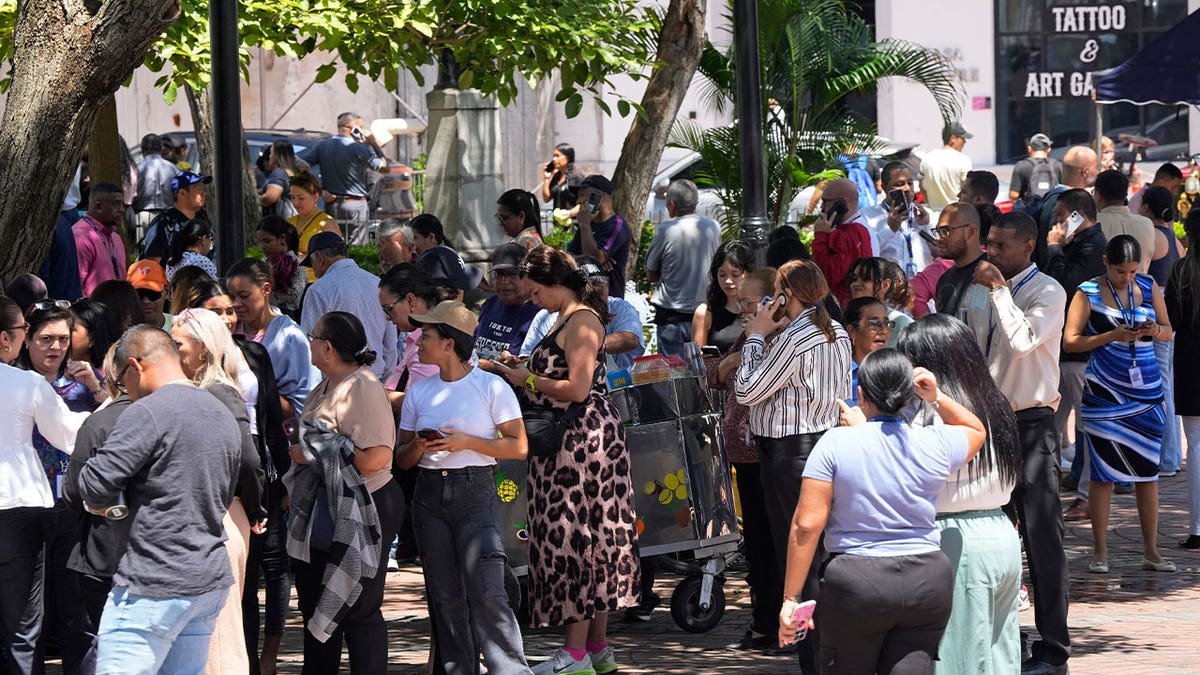 People gather in a square in Panama City after evacuating a building following a powerful earthquake on Oct. 9, 2026