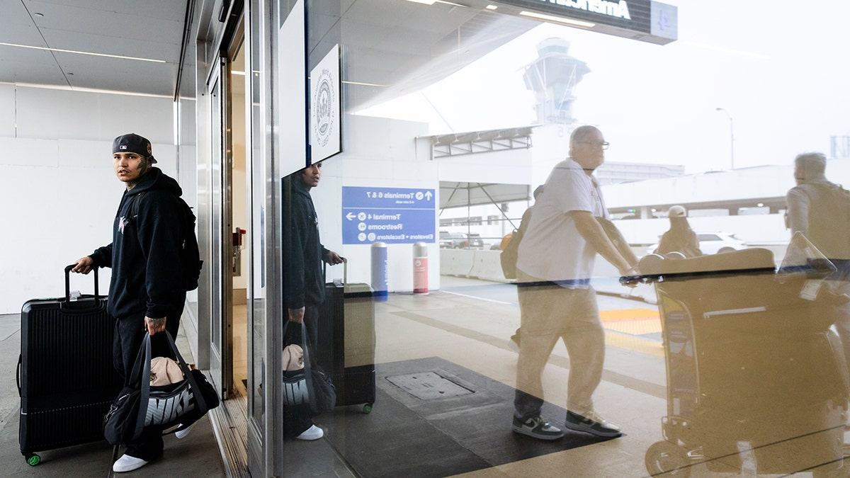 Travelers walking out of a terminal at Los Angeles International Airport.